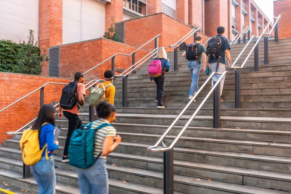 Diverse,Group,Of,University,Students,Climbing,Outdoor,Campus,Stairs,With